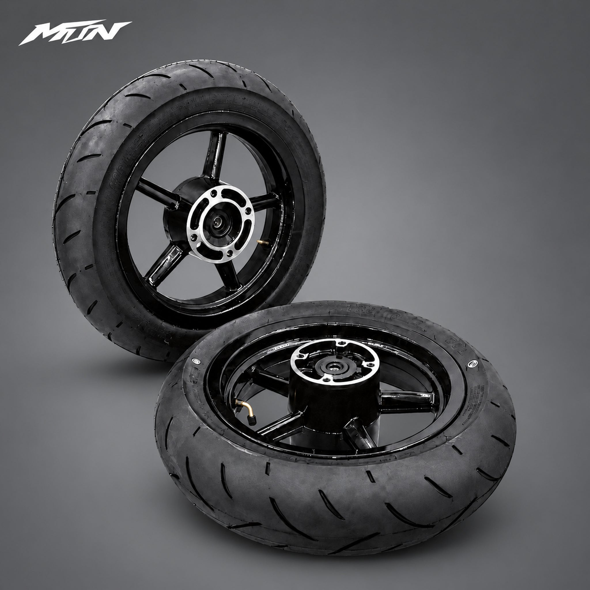 Black aluminum 12-inch supermoto rims with mounted road tires