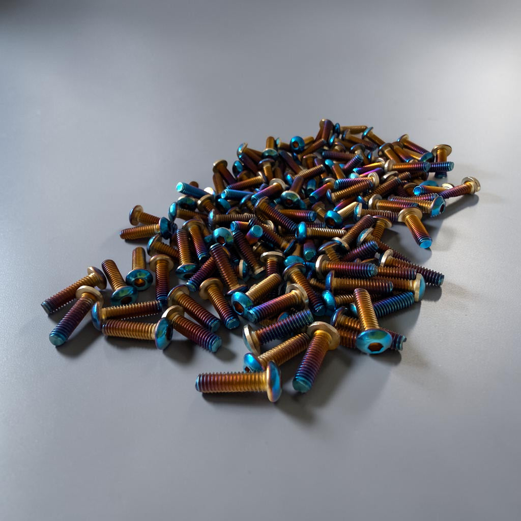 MTN V1 oil slick titanium grip pins for e-moto footpegs, upgrade pins for Sur-Ron, Talaria, Strike Shadow SV2, Tuttio, and Yozma platforms.