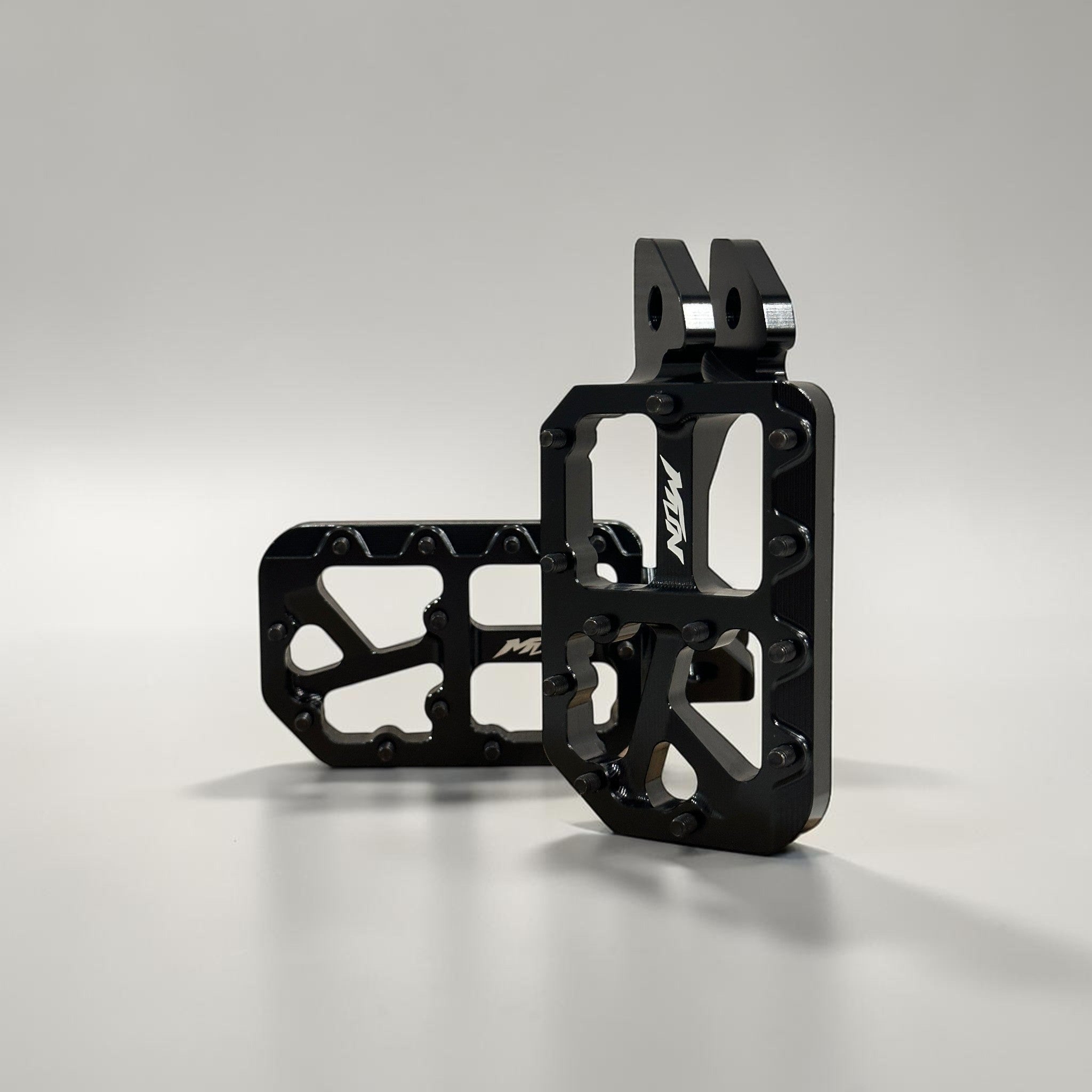 Black MTN Footpegs V1 Series with black titanium grip pins for aggressive e-moto riding