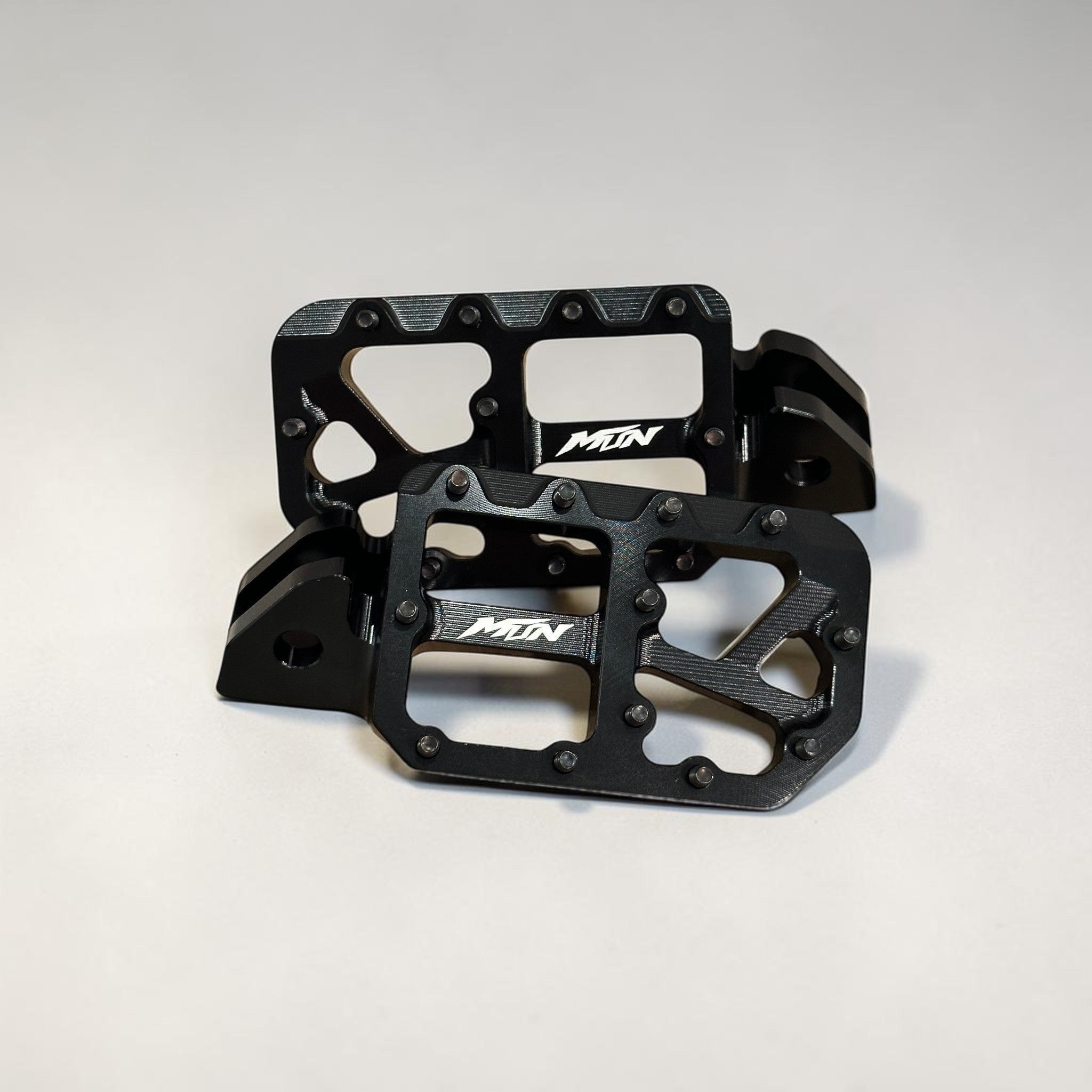 Black MTN Footpegs V1 Series with black titanium grip pins for aggressive e-moto riding