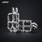 MARK I 7075 wide footpegs with 57mm platforms, raw silver finish and oil slick titanium pins, angled view