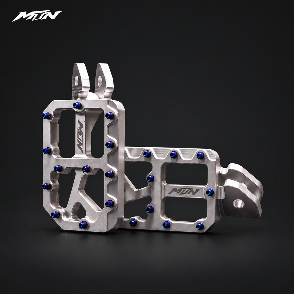 MARK I 7075 wide footpegs with 57mm platforms, raw silver finish and oil slick titanium pins, angled studio view