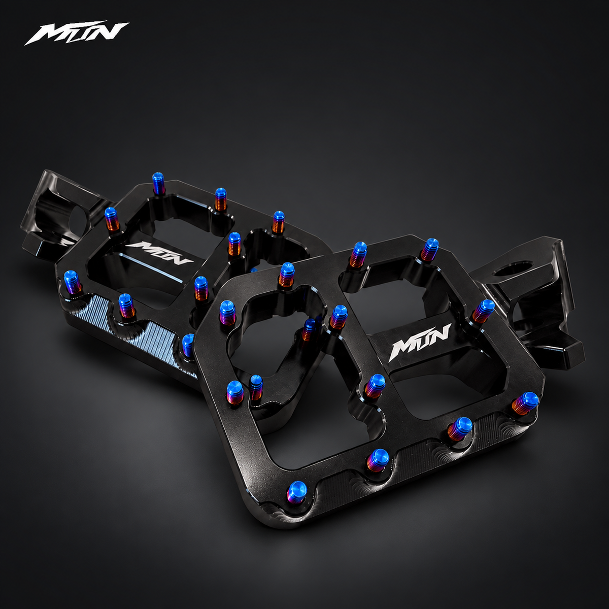 MTN MARK II Wide Performance Footpegs — Black finish, angled action view