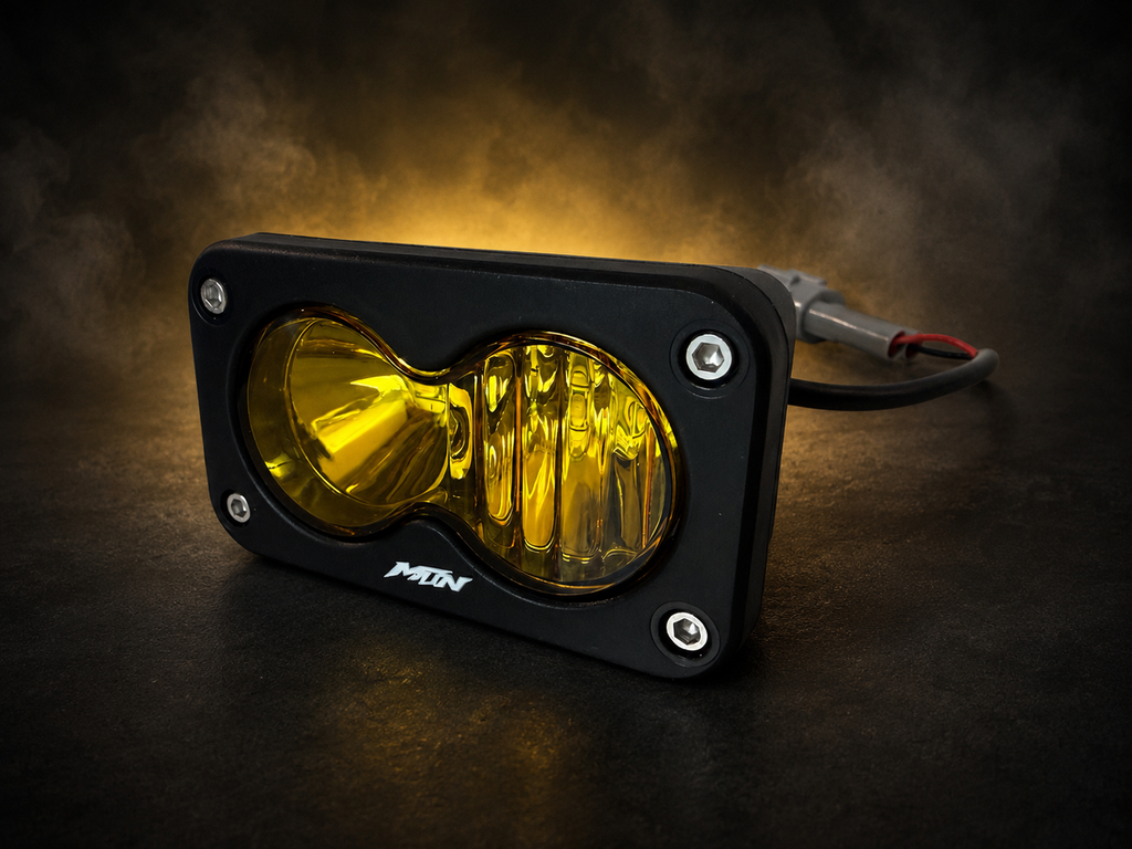 MTN yellow plug-and-play Baja LED headlight for Sur-Ron LBX with connector, angled view