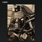 Folding passenger footpeg installed on a Sur-Ron Ultra Bee, showing the silver platform, black support bracket and frame mounting point — MTN MotoWorks