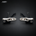 Top-down view of Sur-Ron Ultra Bee passenger footpeg pair folded in and locked against the black brackets — MTN MotoWorks