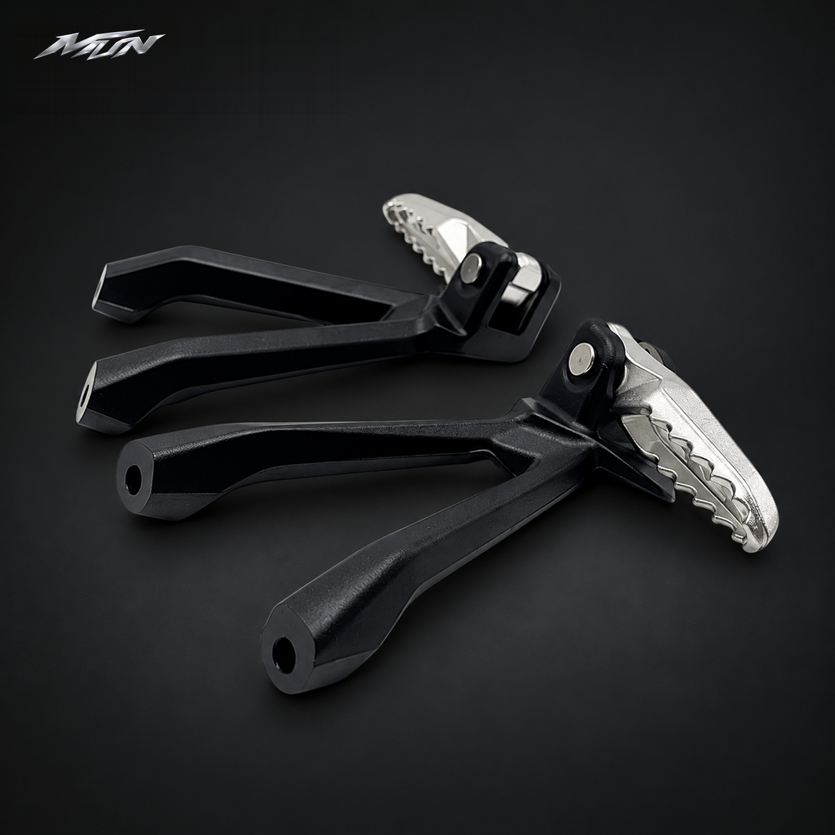 Angled view of Sur-Ron Ultra Bee passenger footpeg pair showing the anti-slip serrated platform and black bracket — MTN MotoWorks