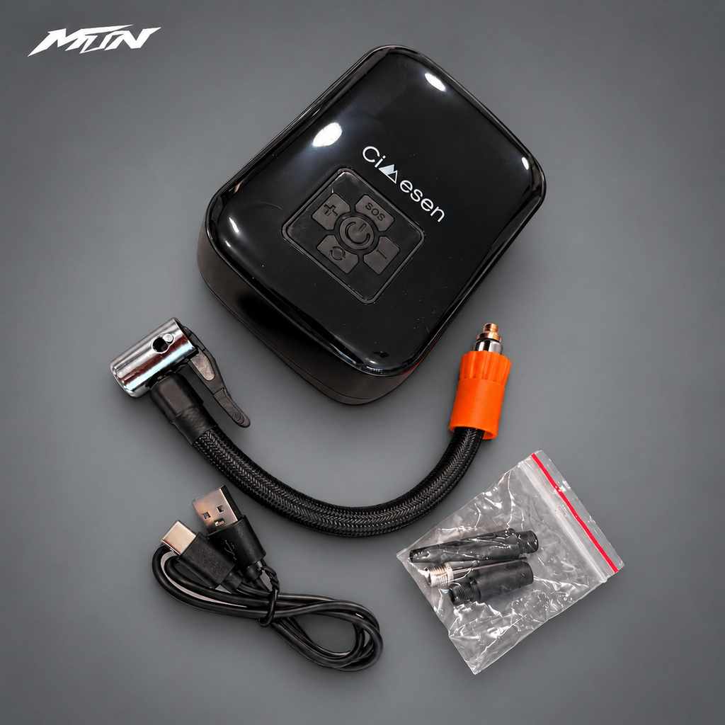 Portable wireless tire inflator with hose and accessories on light charcoal MTN background